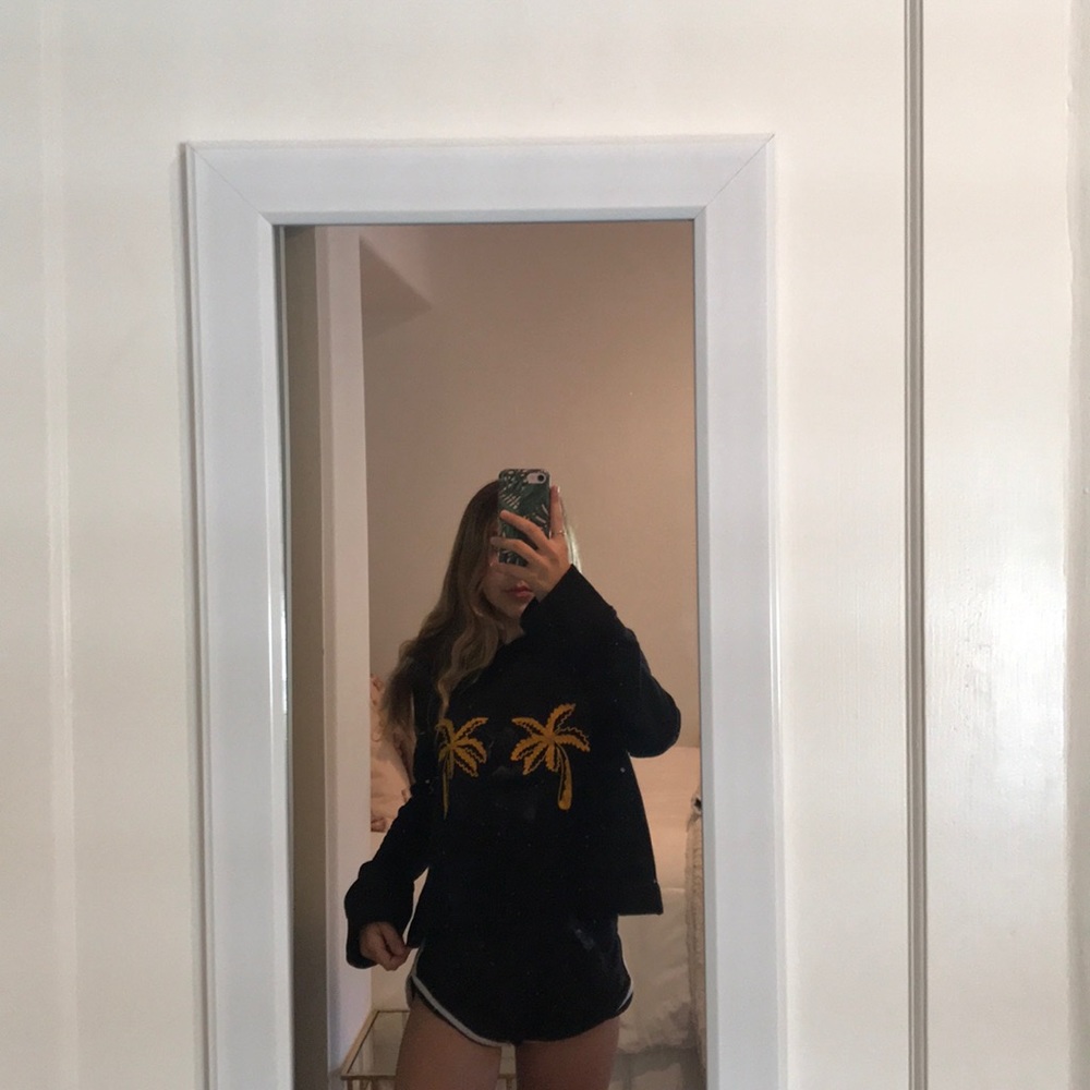black A.L.C sweatshirt with gold palm trees.